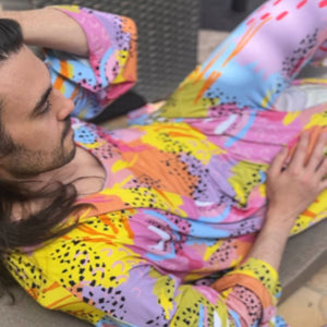 Person wearing Pronoun by Jesse Tyler Ferguson x MiliMili Modern Rainbow Adult Robe, bamboo robe
