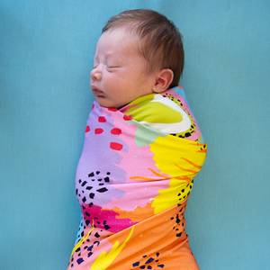 modern rainbow print swaddle set by milimili in collaboration with pronoun by jesse tyler ferguson