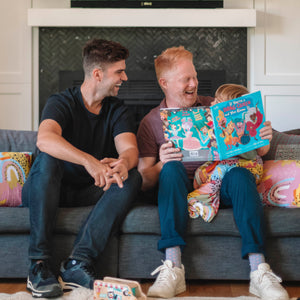 jesse tyler ferguson and justin mikita reading 'If You're a Drag Queen and You Know it' to their son Beckett
