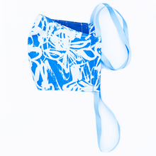 Load image into Gallery viewer, tropical face mask - blue and white modern abstract art print cloth face mask with blue and hot pink stars on back and blue cloth straps.