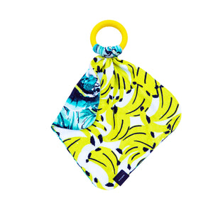 Tropical banana print lovey with palm print on reverse side in silky soft bamboo jersey with teething ring for baby soothing  Edit alt text