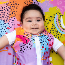 Load image into Gallery viewer, Baby wearing MiliMili x Pronoun by Jesse Tyler Ferguson Modern Rainbow Wearable Blanket on Modern Rainbow Crib Sheet, best crib sheet, bamboo crib sheet