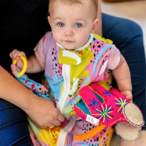 Adorable baby with Modern Rainbow print lovey by MiliMili, in collaboration with Pronoun by Jesse Tyler Ferguson