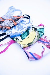 MiliMili cloth face mask summer collection featuring tropical bright prints with bananas, fish, artful swirls, and crane prints
