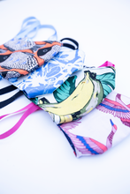 Load image into Gallery viewer, MiliMili cloth tropical face mask summer collection featuring tropical bright prints with bananas, fish, artful swirls, and crane prints