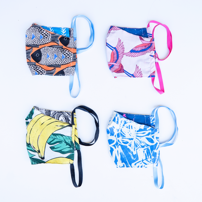 milimili summer collection face mask four-pack, featuring blue modern print, orange fish print, banana print, and pink crane print