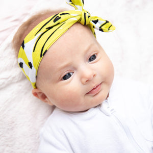MiliMili Kona Banana bow in silky soft bamboo jersey, shown on six week old baby