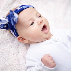 MiliMIli playa blue tie dye baby bow in bamboo jersey, shown on six week old baby