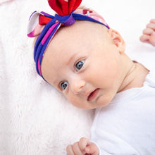 Load image into Gallery viewer, MiliMili puebla rosa pink floral baby bow in bamboo jersey, shown on 6 week old baby