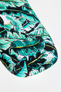 Close up shot of Kauai One (palm print) bassinet sheet featuring green and bright yellow banana leaves