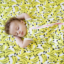 Load image into Gallery viewer, Baby sleeping on MiliMili tropical banana print bamboo crib sheet shown in modern crib, softest crib sheet ever, bamboo crib sheet, best crib sheet