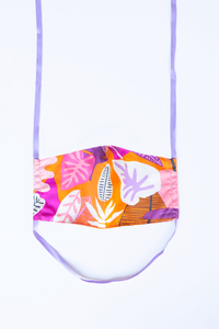 front of milimili guava face mask - featuring purple orange and pink tropical print 