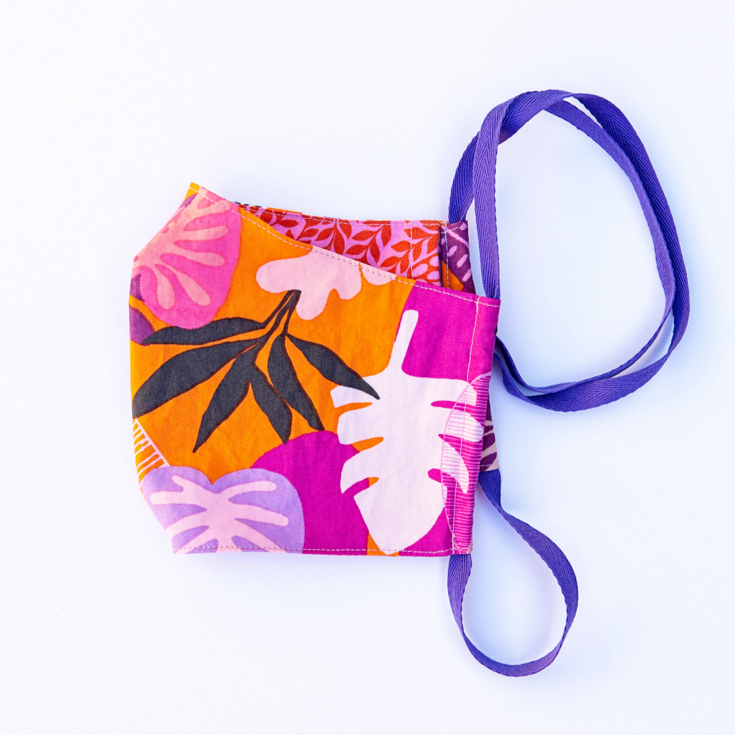 MiliMili face mask with Tropical purple orange and pink print front with reversible red and pink floral print back. 