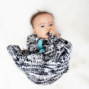 baby wearing black and white watercolor sleep sack with aquamarine contrast trim. best sleep sacks for toddlers. 