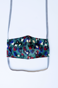 front of milimili leopard face mask - featuring dark teal, blue and red leopard print 