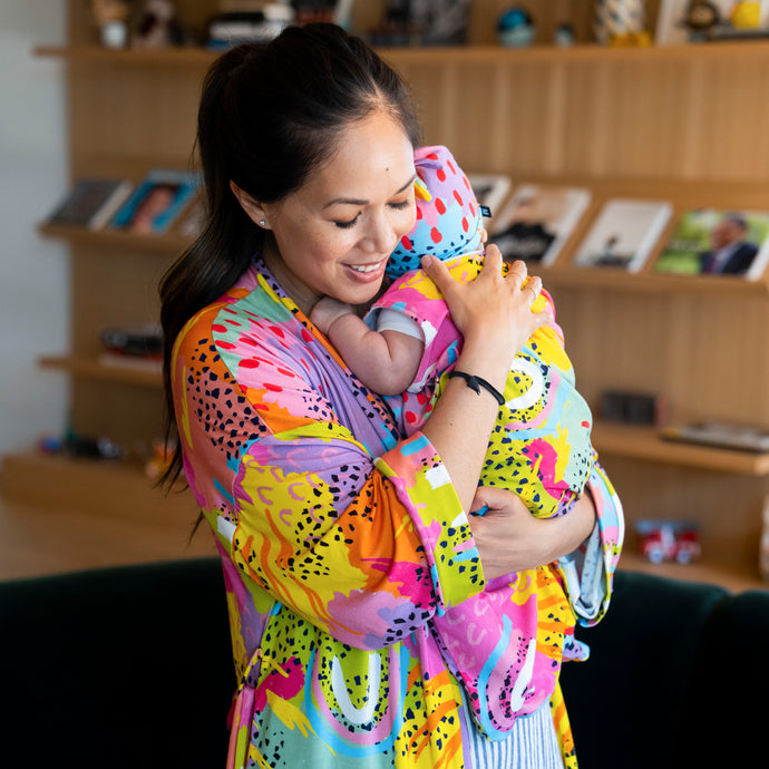 Modern Rainbow robe as shown on mom holding baby. Created by MiliMili in collaboration with Pronoun by Jesse Tyler Ferguson, bamboo robe, mom matching daughter