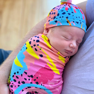 modern rainbow print swaddle set by milimili in collaboration with pronoun by jesse tyler ferguson