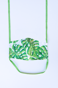 front of milimili monstera palm print face mask - featuring green monstera leaf print