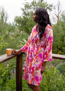 woman wearing tropical lightweight robe while enjoying coffee
